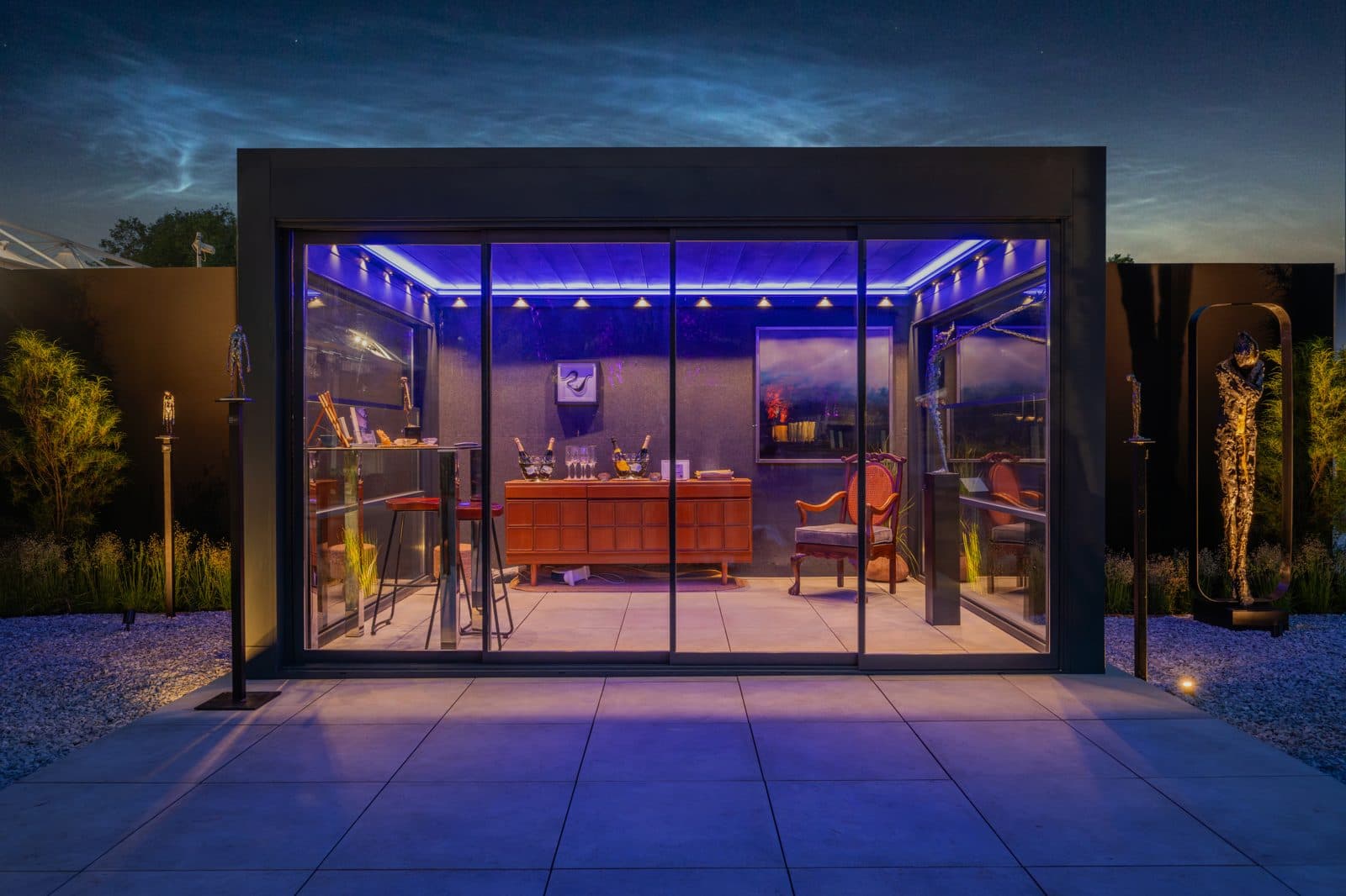Bioclimatic pergola with deep blue ambient lighting