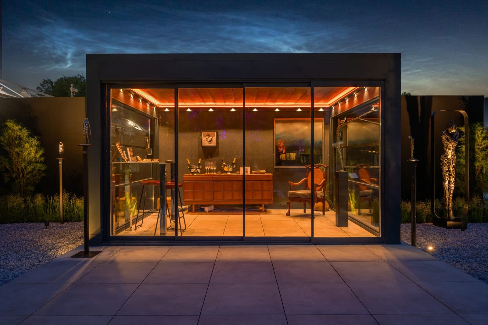 Bioclimatic pergola with amber ambient lighting