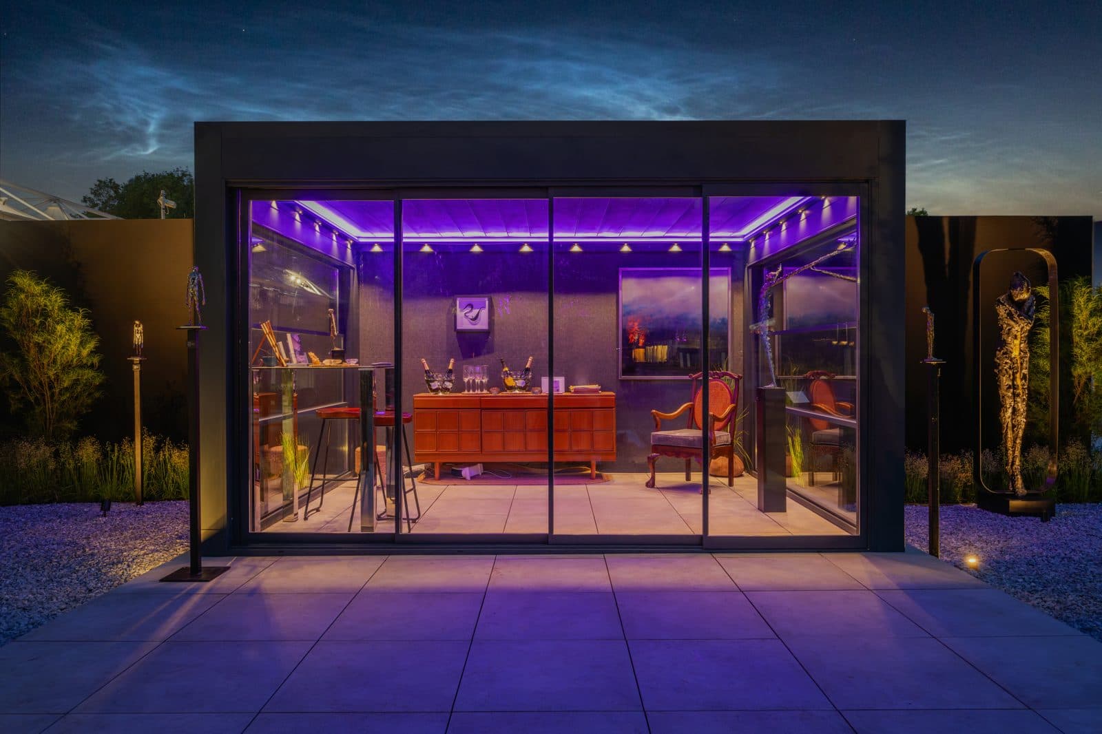 Bioclimatic pergola with purple ambient lighting