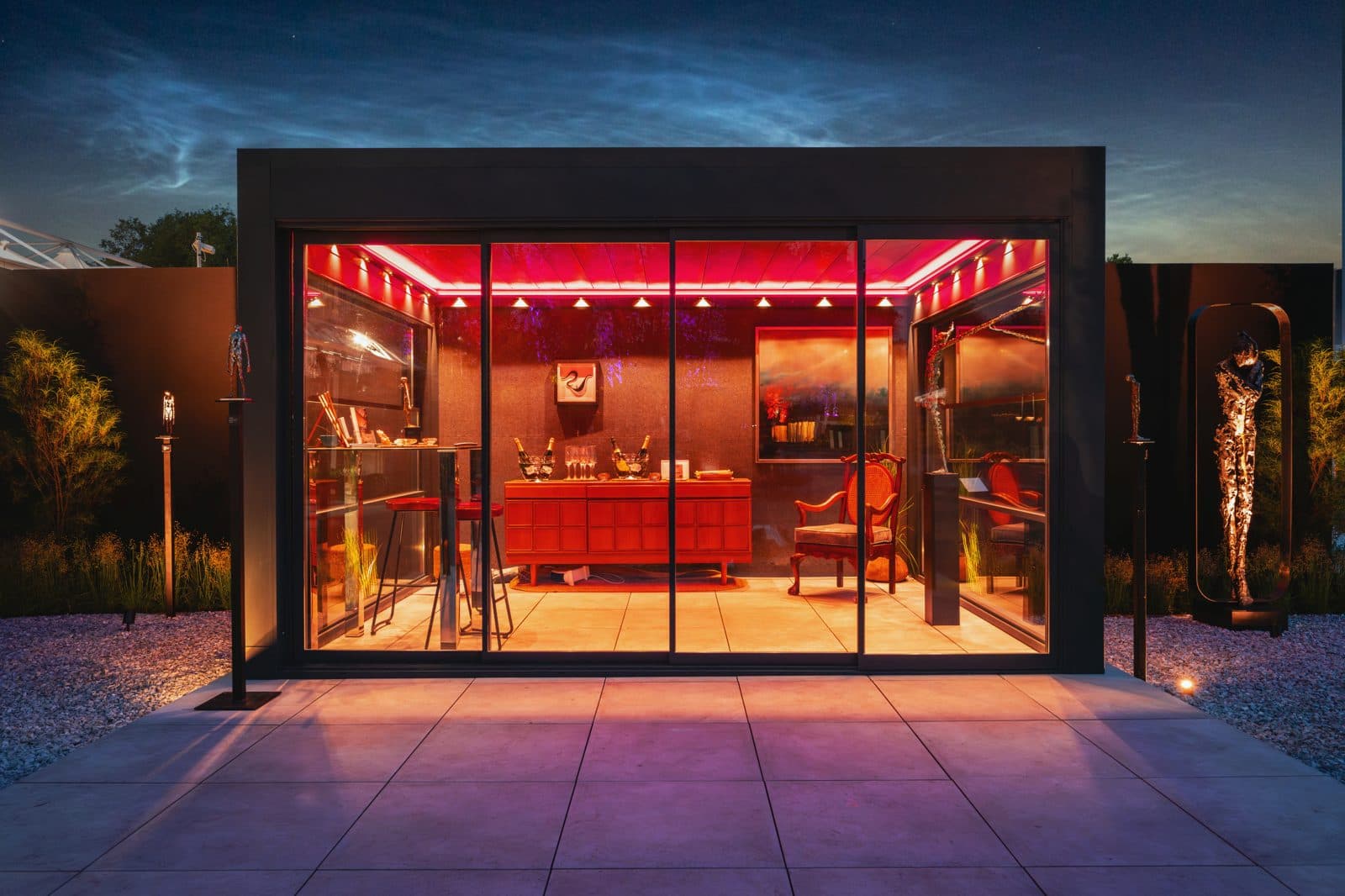 Bioclimatic pergola with red ambient lighting